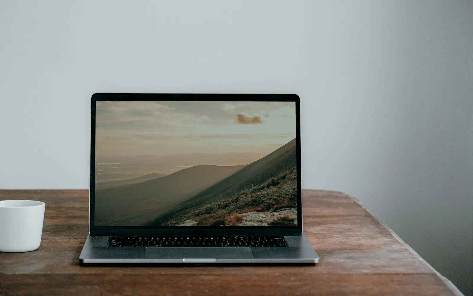 Laptop on a wooden table — serviced by Mount Vernon Computers