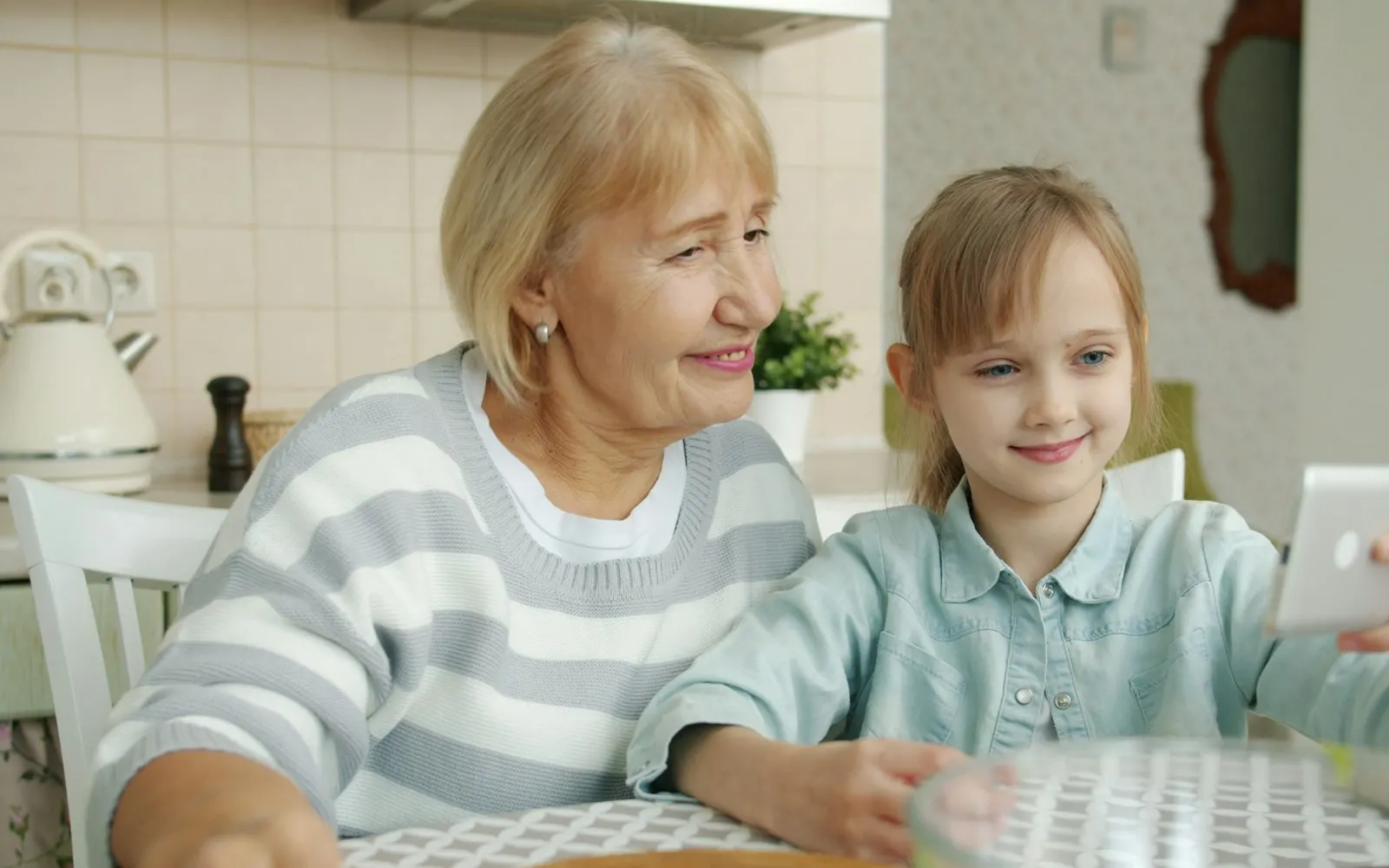 Grandparent and child learning on a laptop together