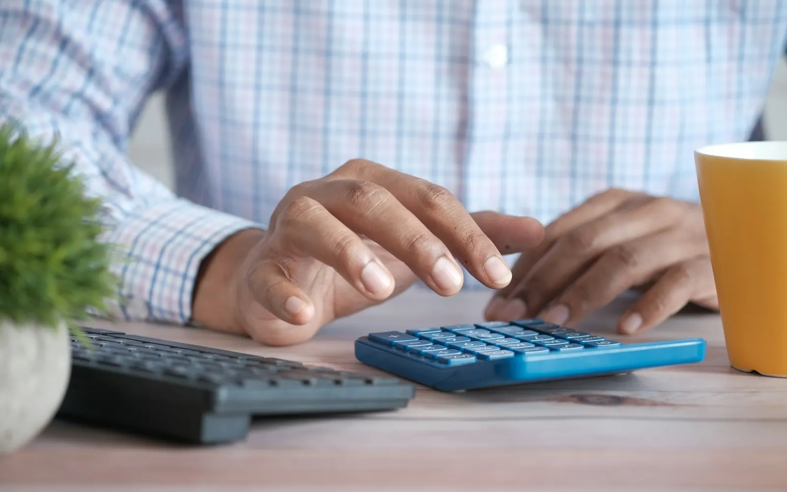 Accountant working with a calculator and laptop