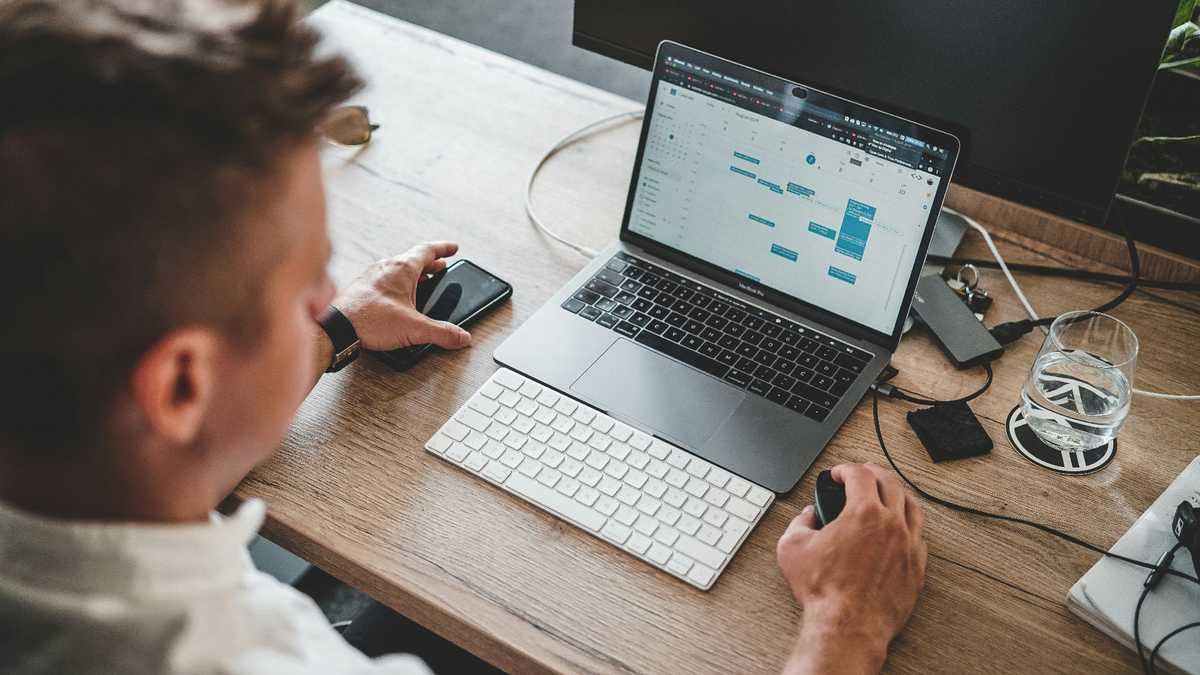 Small business owner managing their calendar and website on a laptop in Alexandria, Northern Virginia